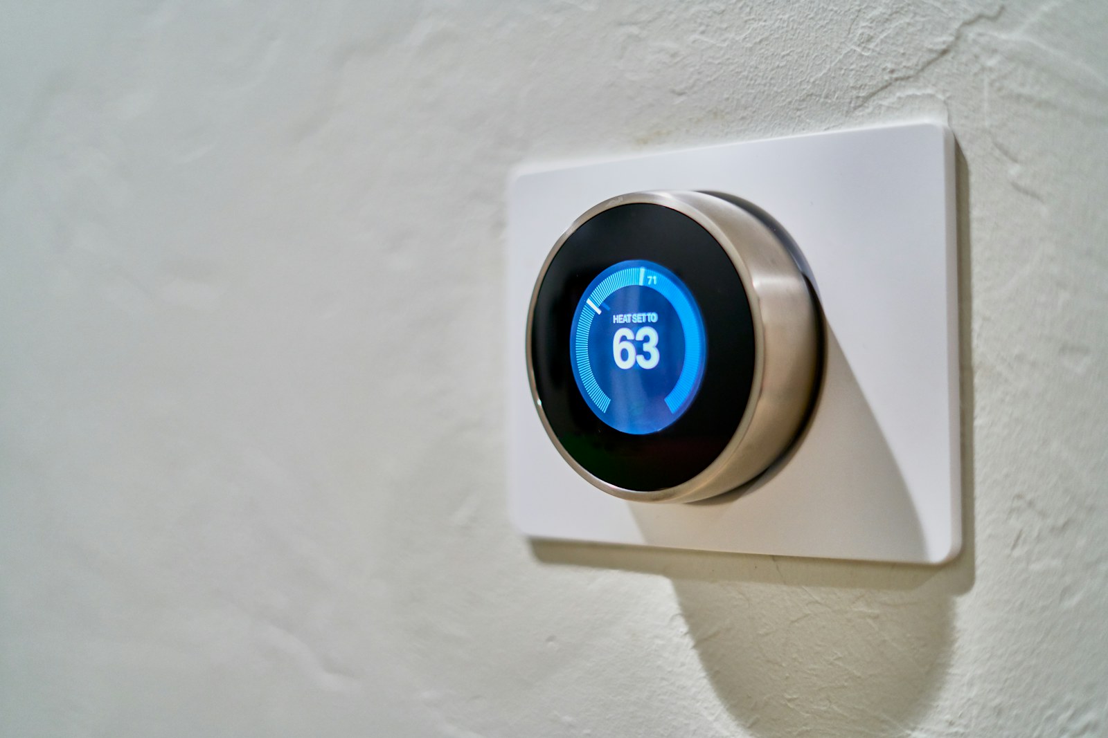 Wall-mounted smart thermostat controlling home temperature